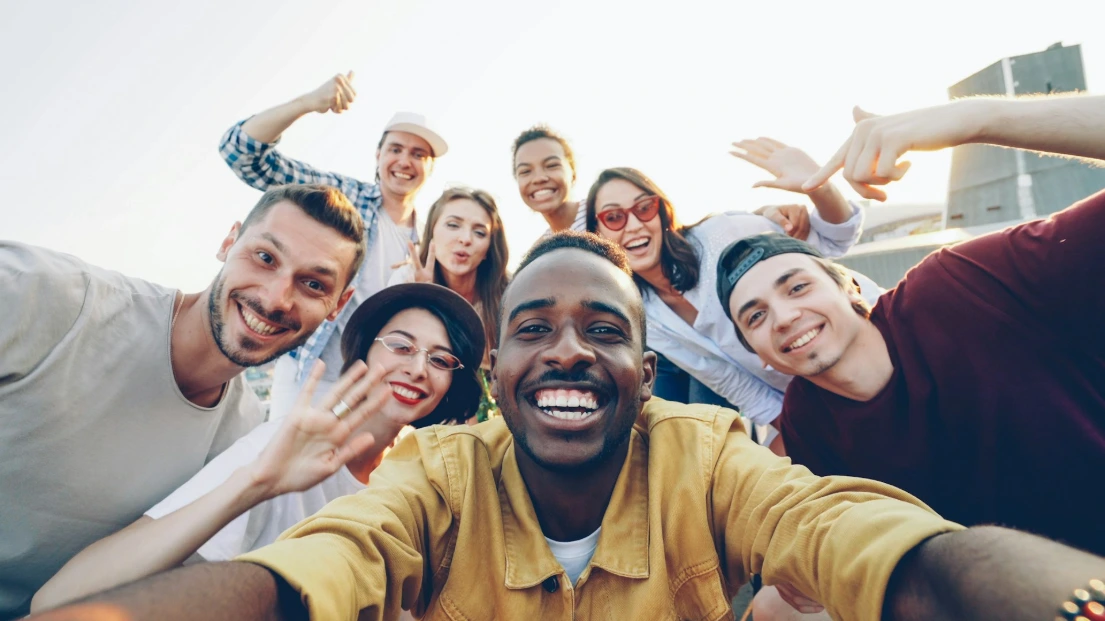 A diverse group of happy friends taking a selfie fro HR